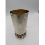 A sterling silver beaker scenes of Jerusalem around the base, gilt interior, stamped sterling 925,