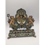 A Sterling silver cloisonne enamelled oil lamp menorah, stamped sterling, raised on four paw feet,