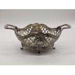 A late 19th century pierced twin handled silver dish by William Moering, the cartouches depicting