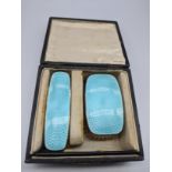 An early 20th century silver and turquoise guilloche enamel vanity set, comprising of 2 brushes, a