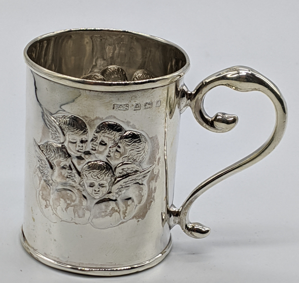An Edwardian small silver mug, embossed with angels, hallmarked Birmingham, 1902-03, maker L&S, 48g,
