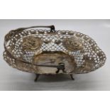 A Continental silver basket, pierced and embossed with swing handle, indistinct mark to interior