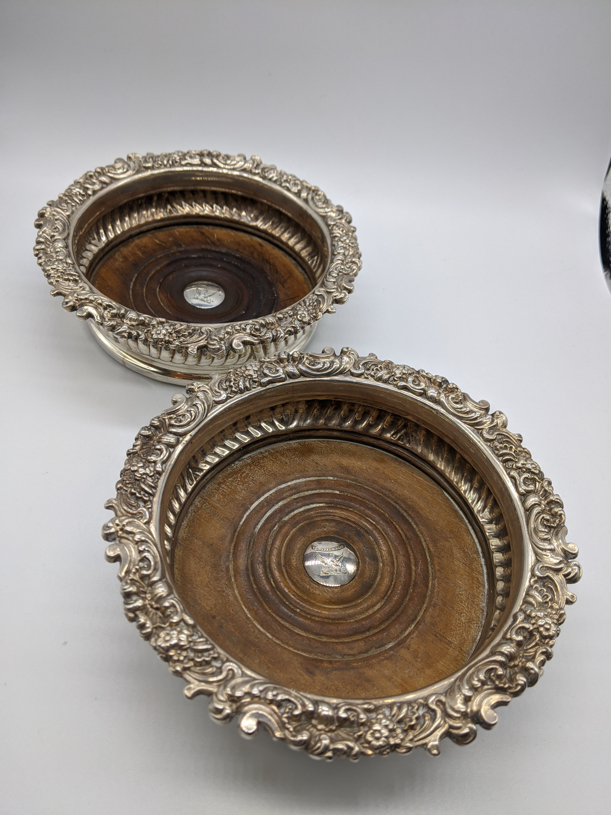 A pair of George IV silver coasters, central crest plaques, hallmarked Sheffield, 1822-23, 568g, D.