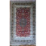 A Persian silk rug navy and red ground, central medallion, 185cm x 125cm