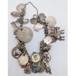 A silver chain bracelet with silver charms and coins, various marks, 63g