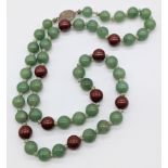 A Jade bead necklace, silver clasp