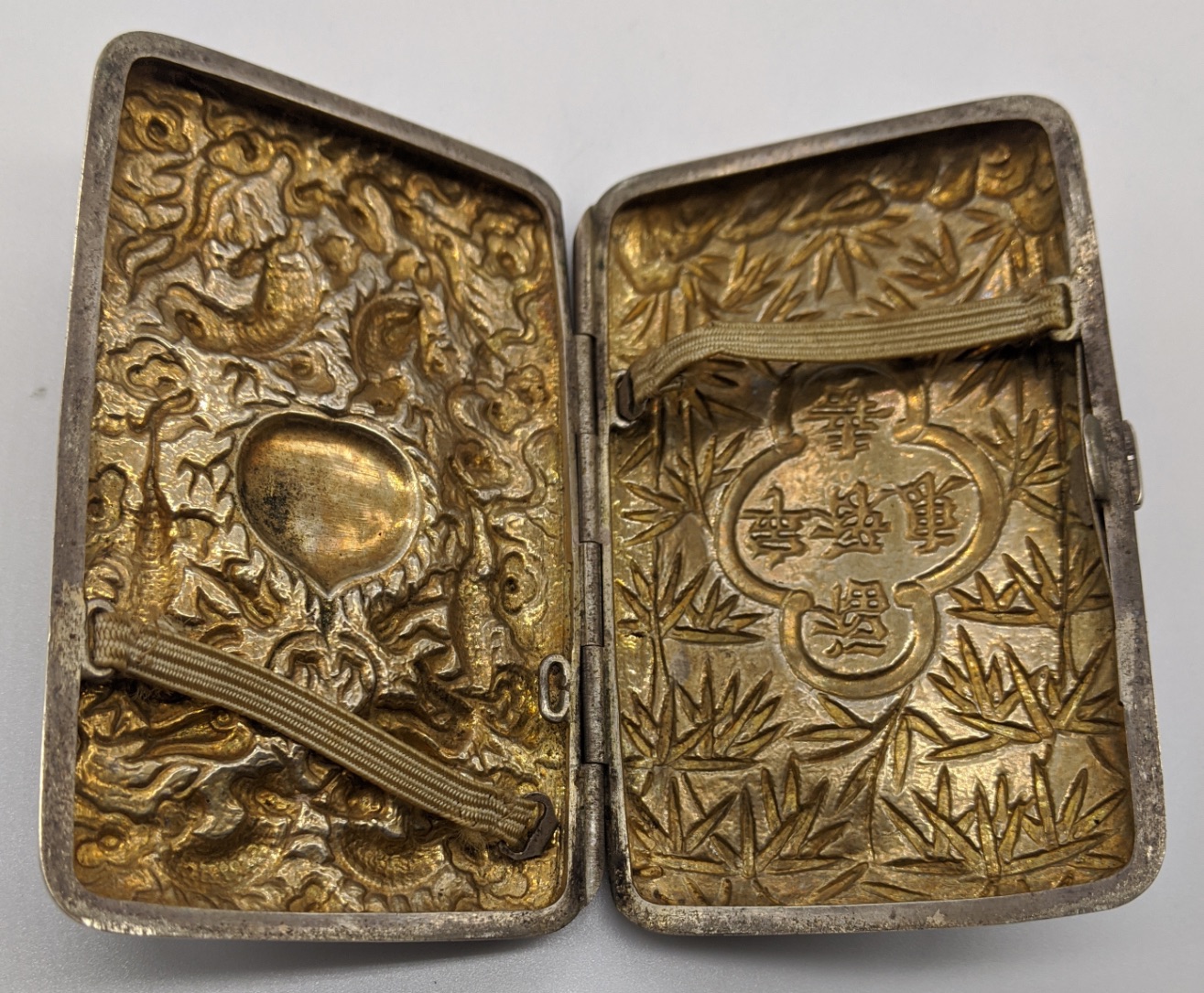 A late 19th century Chinese export silver cigarette box, decorated with chased dragons, bamboo and - Image 3 of 4