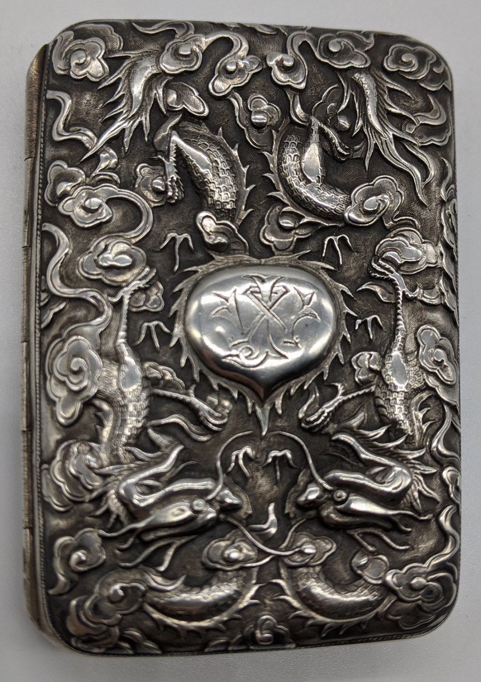 A late 19th century Chinese export silver cigarette box, decorated with chased dragons, bamboo and - Image 2 of 4