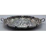 A Victorian silver twin handled wine taster, repousse embossed depicting a king on the throne, hall
