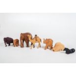 Konvolut exotischer TiereTeils Holz geschnitzt, glasierter Ton. 4 Elefanten, Kamel, Warzenschwein,