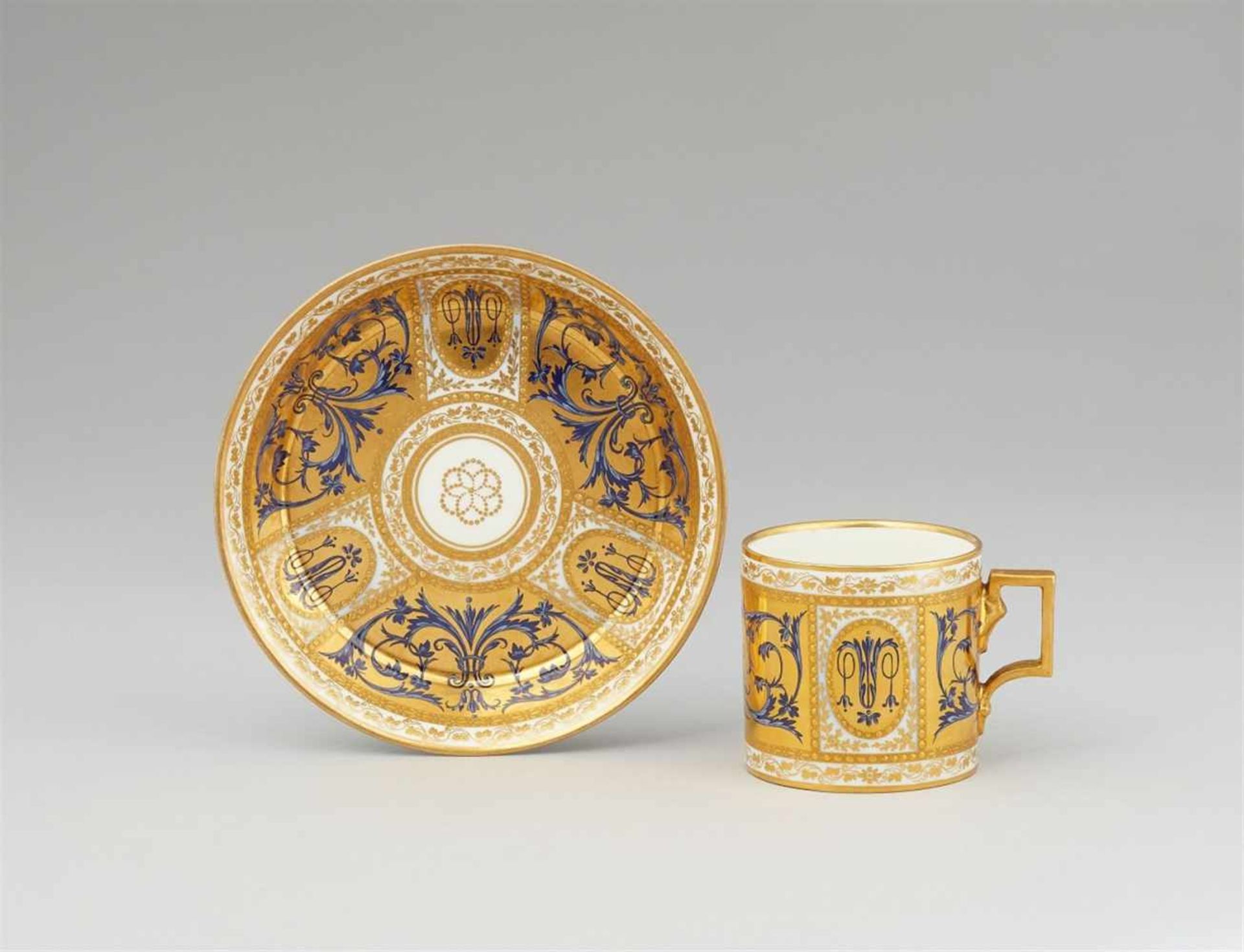 A Vienna porcelain cup and saucer with blue arabesquesOf cylindrical form with original saucer,