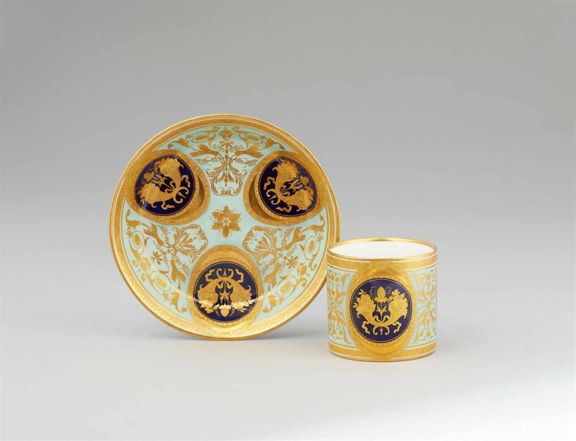 A Vienna porcelain cup and saucer with gold cornucopia motifsOf cylindrical form with original