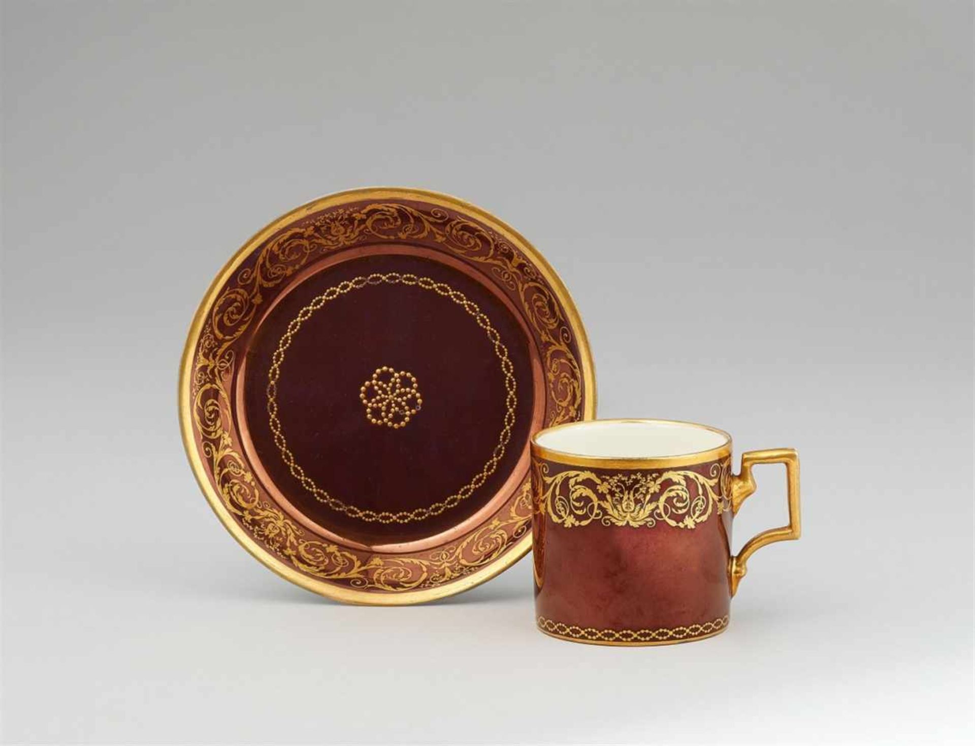 A Vienna porcelain cup and saucer with gilt arabesquesOf cylindrical form with original saucer.