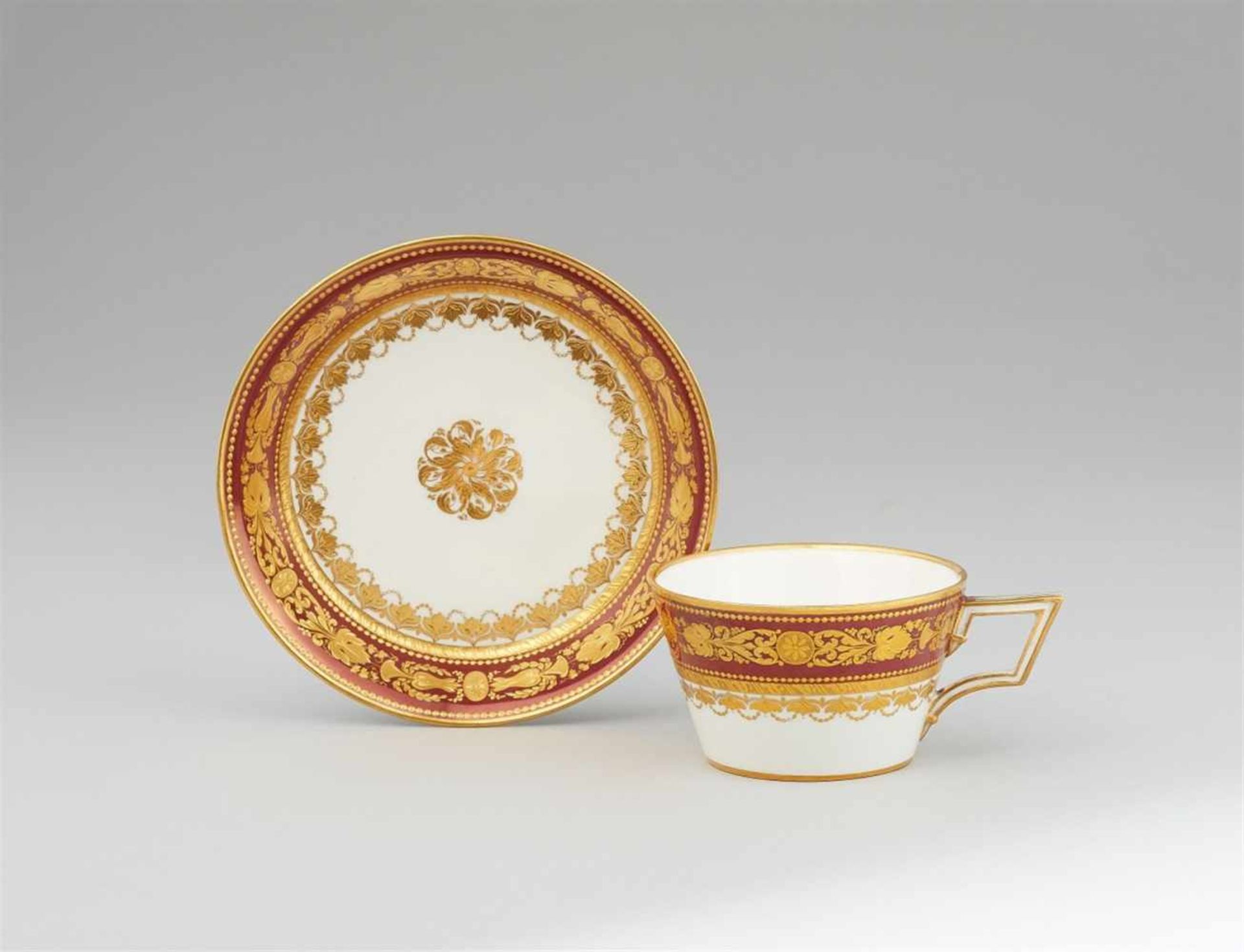 A Vienna porcelain cup and saucer with a lustre borderOf conical form with original saucer. Blue