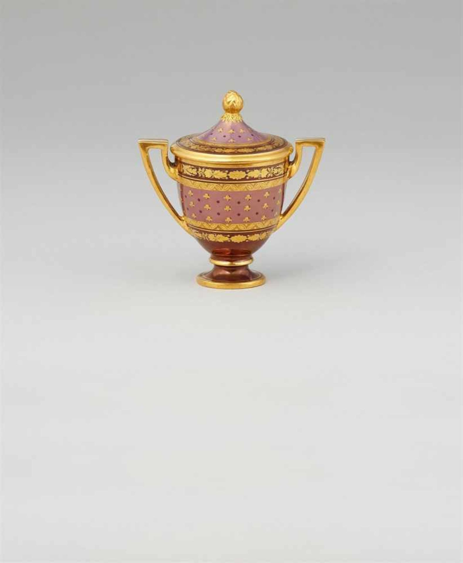 A small Vienna porcelain vase with lustre groundUrn with angular handles and cover with a pinecone