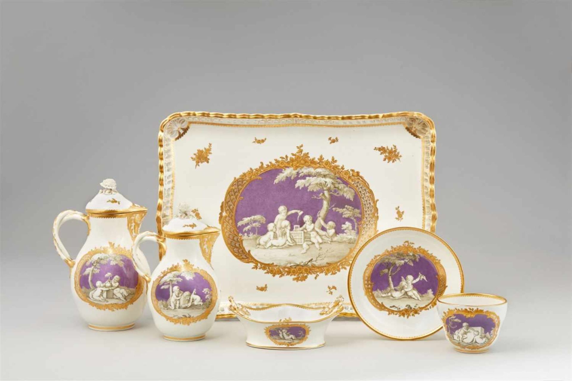 A Vienna porcelain dejeuner with children en grisaille on lilac groundComprising a rectangular