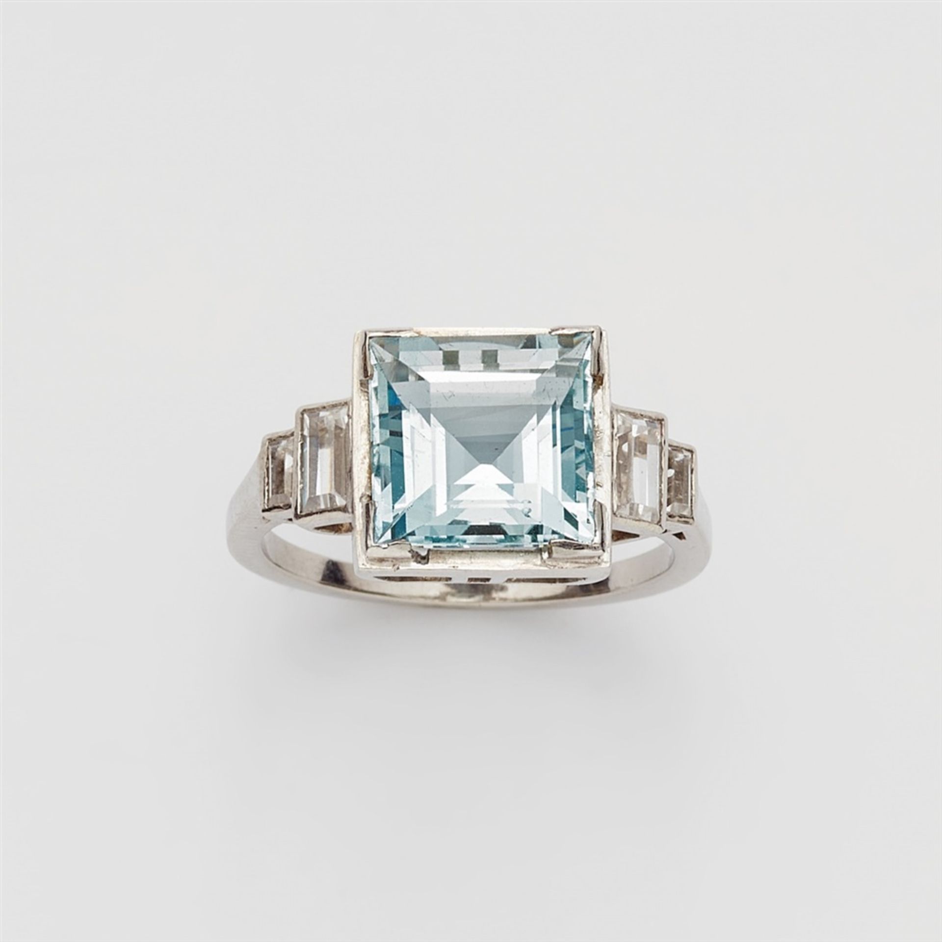 A platinum and aquamarine ringThe carré-cut aquamarine (4.53 ct, c. 9.39 x 9.42 x 6.33 mm) flanked