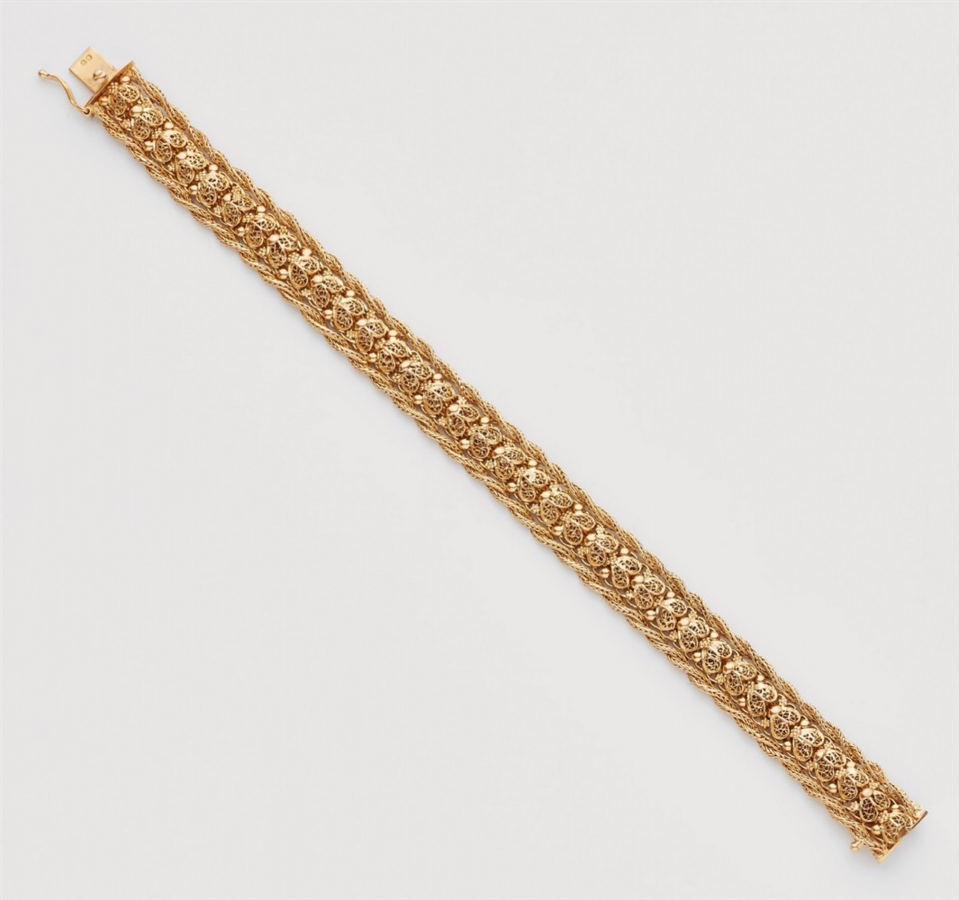 An 18k gold meshwork braceletDesigned as a braided band with filigree decor. Hallmarks: Fineness 800