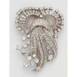 A platinum and diamond clip broochPlatinum brooch of curving openwork design, fully set with 8/8-,