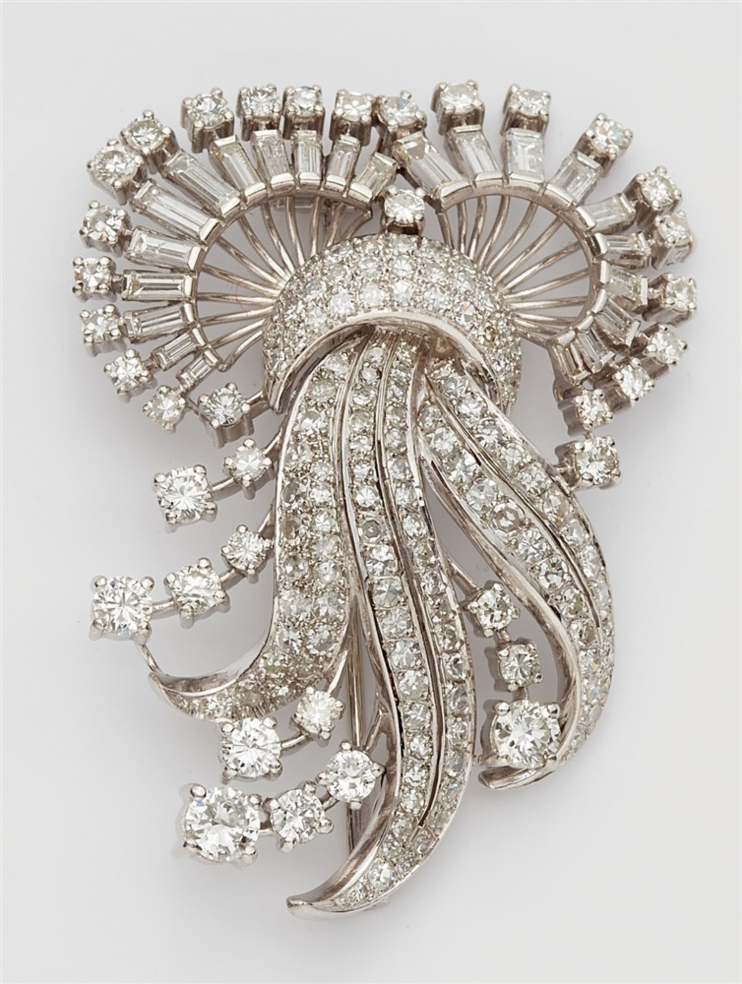 A platinum and diamond clip broochPlatinum brooch of curving openwork design, fully set with 8/8-,