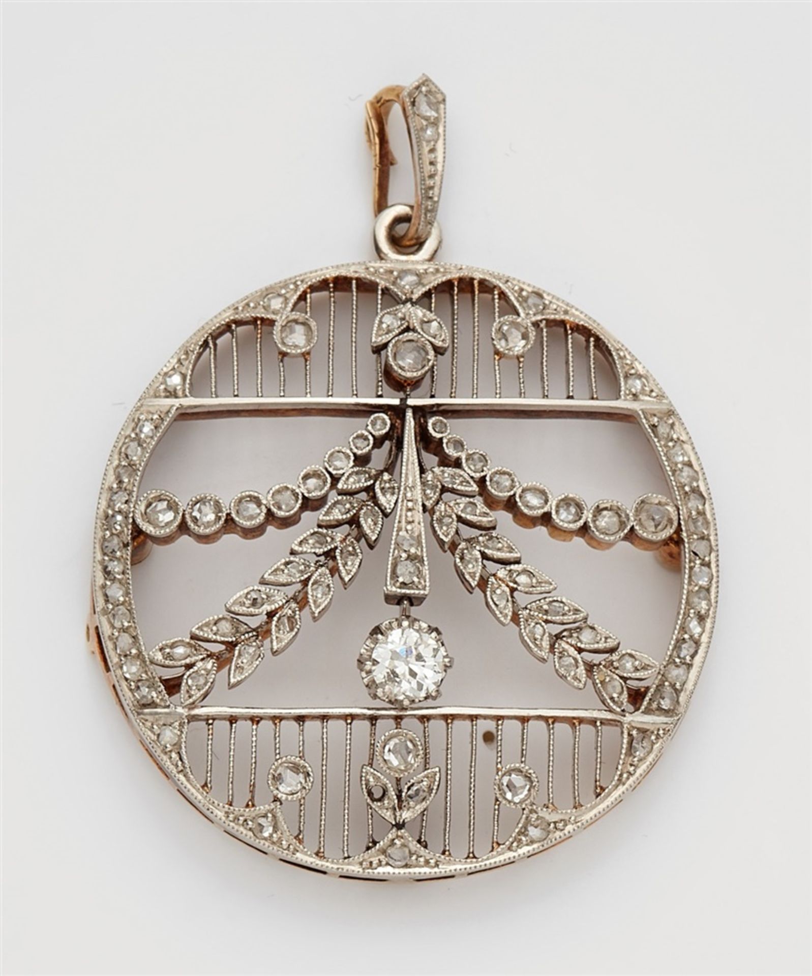 A Belle Epoque 14k gold and diamond pendantPlatinum and 14k gold pendant designed as a delicately