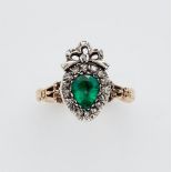 A 14k gold, emerald and diamond George III Claddagh ringA silver and 14k gold ring with a curved