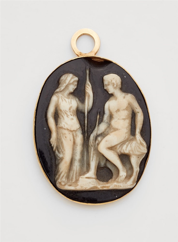 An 18k gold and agate cameo pendantThe oval layered onyx cameo (33 x 27 mm) carved in relief with