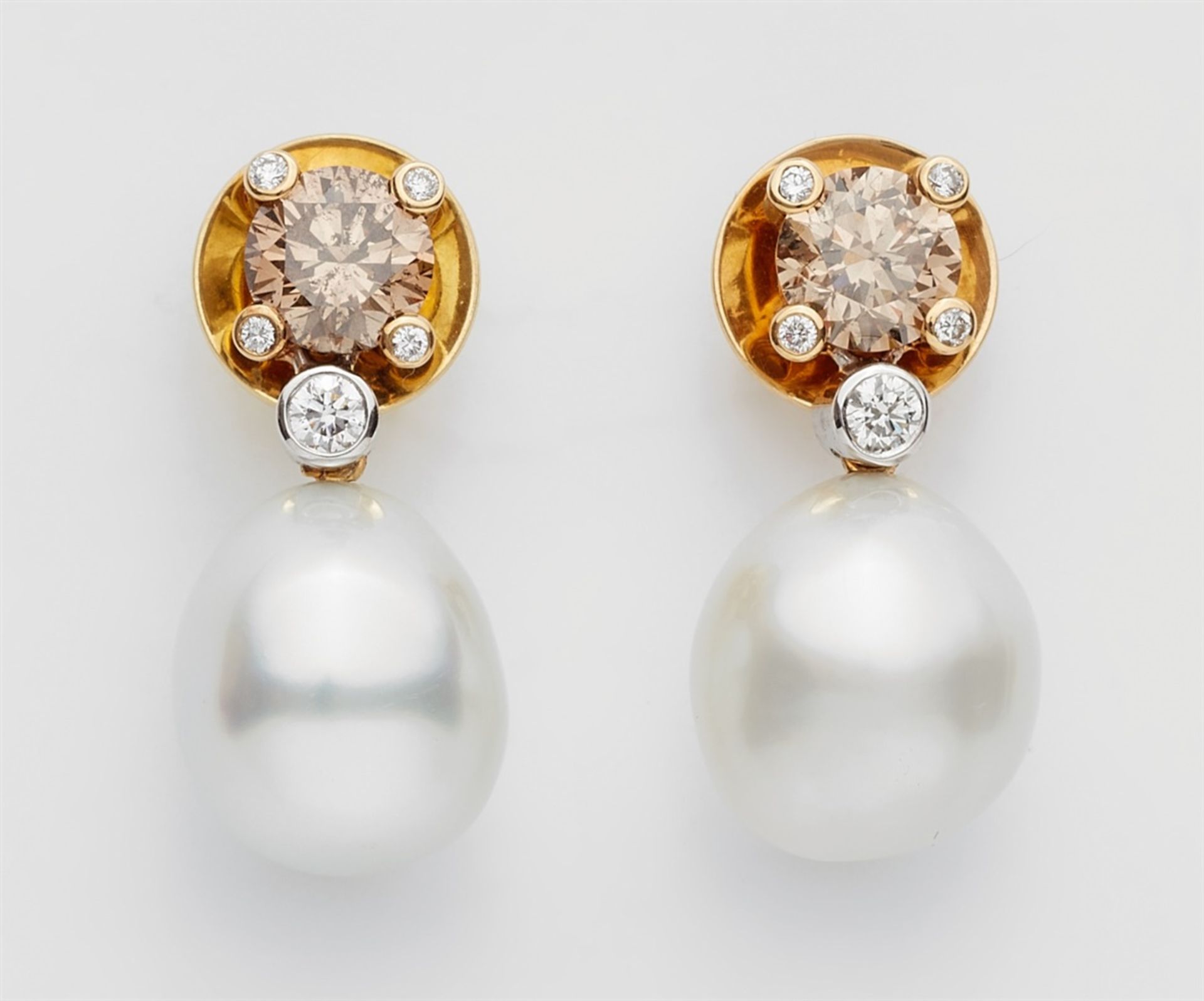 A pair of 18k gold, pearl and fancy diamond earringsStud earrings each set with a small natural