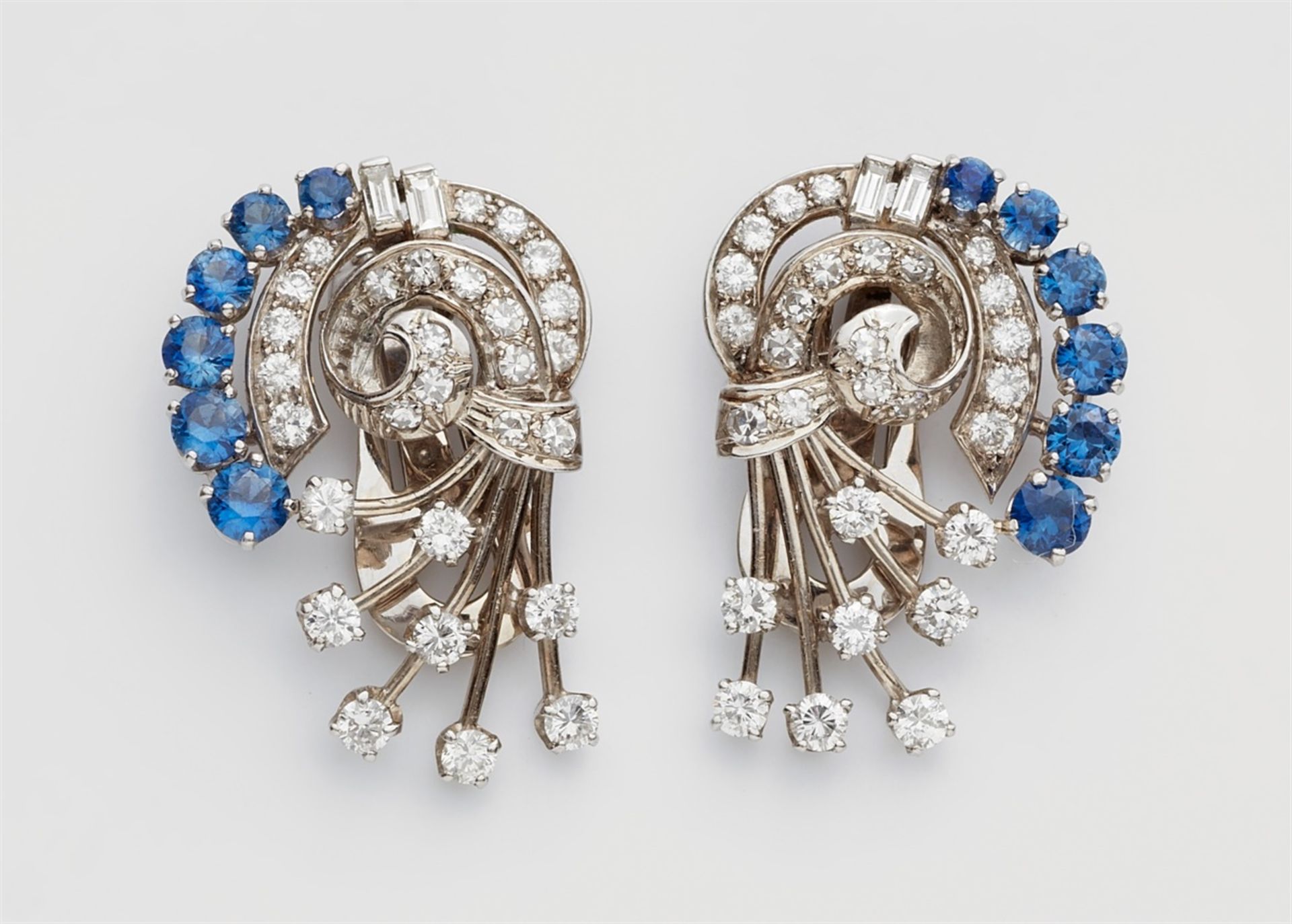 A pair of sapphire clip earringsPlatinum earrings with 14k white gold clip findings. Designed as