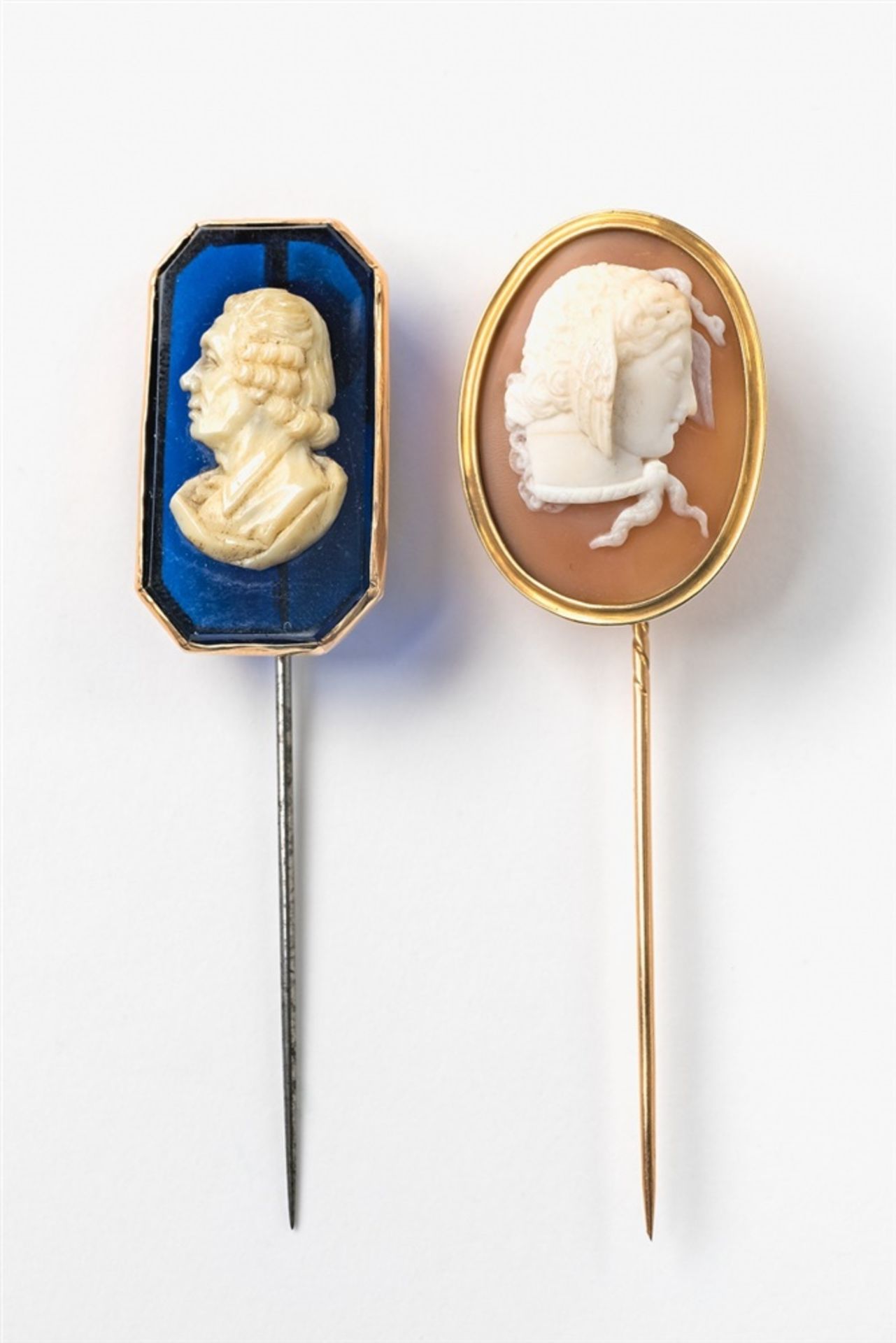 Two cameo pins1) Portrait of a man in profile, carved bone on blue glass, steel pin, 3.1 x 1.8 cm,