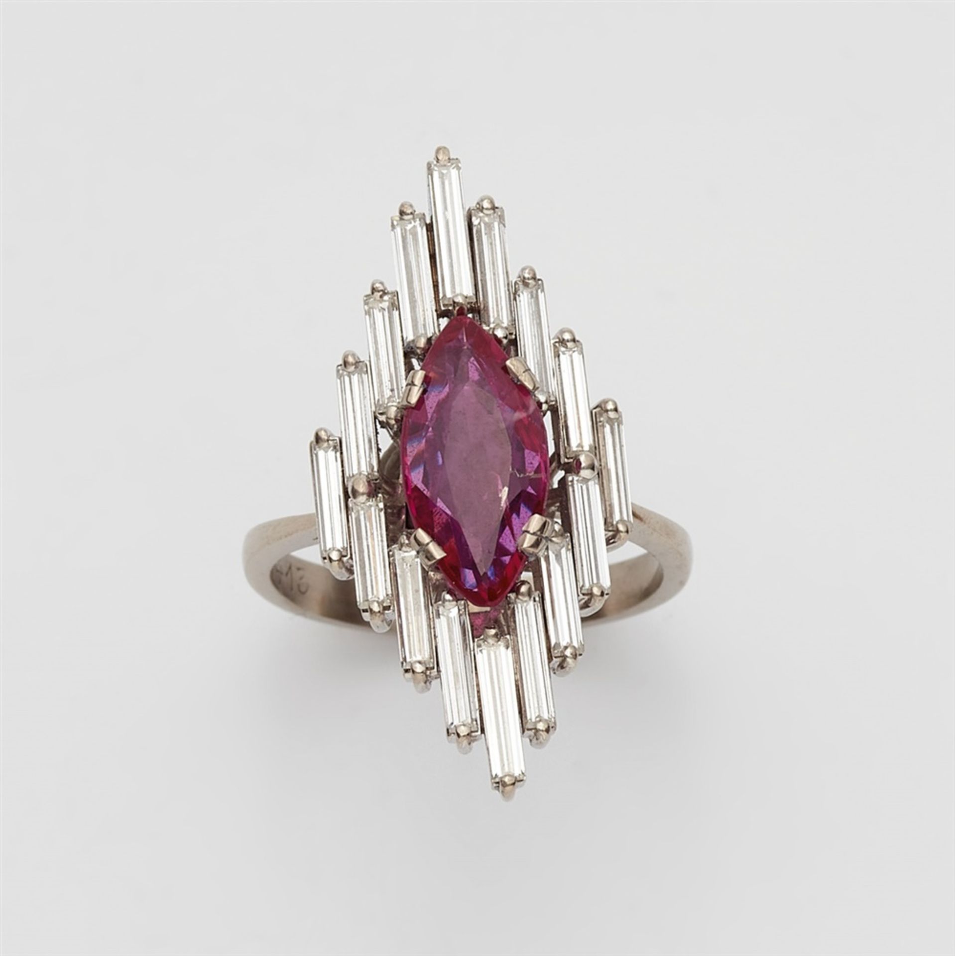 An 18k white gold and diamond marquise ring with a Burmese rubyThe elongated bezel set with a