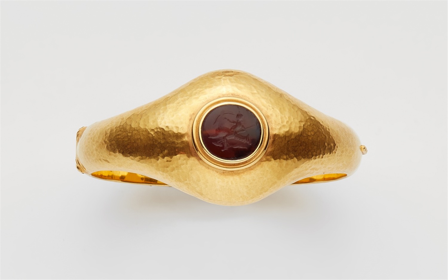 An 18k gold pin brooch with Roman coinsForged bangle with martelé decor, the flaring upper face