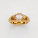 An 18k gold and moonstone ringMatte ring band set with a moonstone cabochon (diameter 7.19 x 3.49
