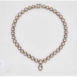 An 18k white gold and grey moonstone necklaceA rivière-form necklace designed as a strand of round