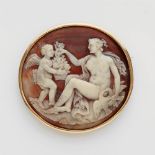 An 18k gold and shell cameo brooch with Venus and CupidA thick, round sea snail cameo carved with