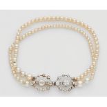 An Oriental pearl bracelet with a diamond claspA two-stranded bracelet made from 44/52 small