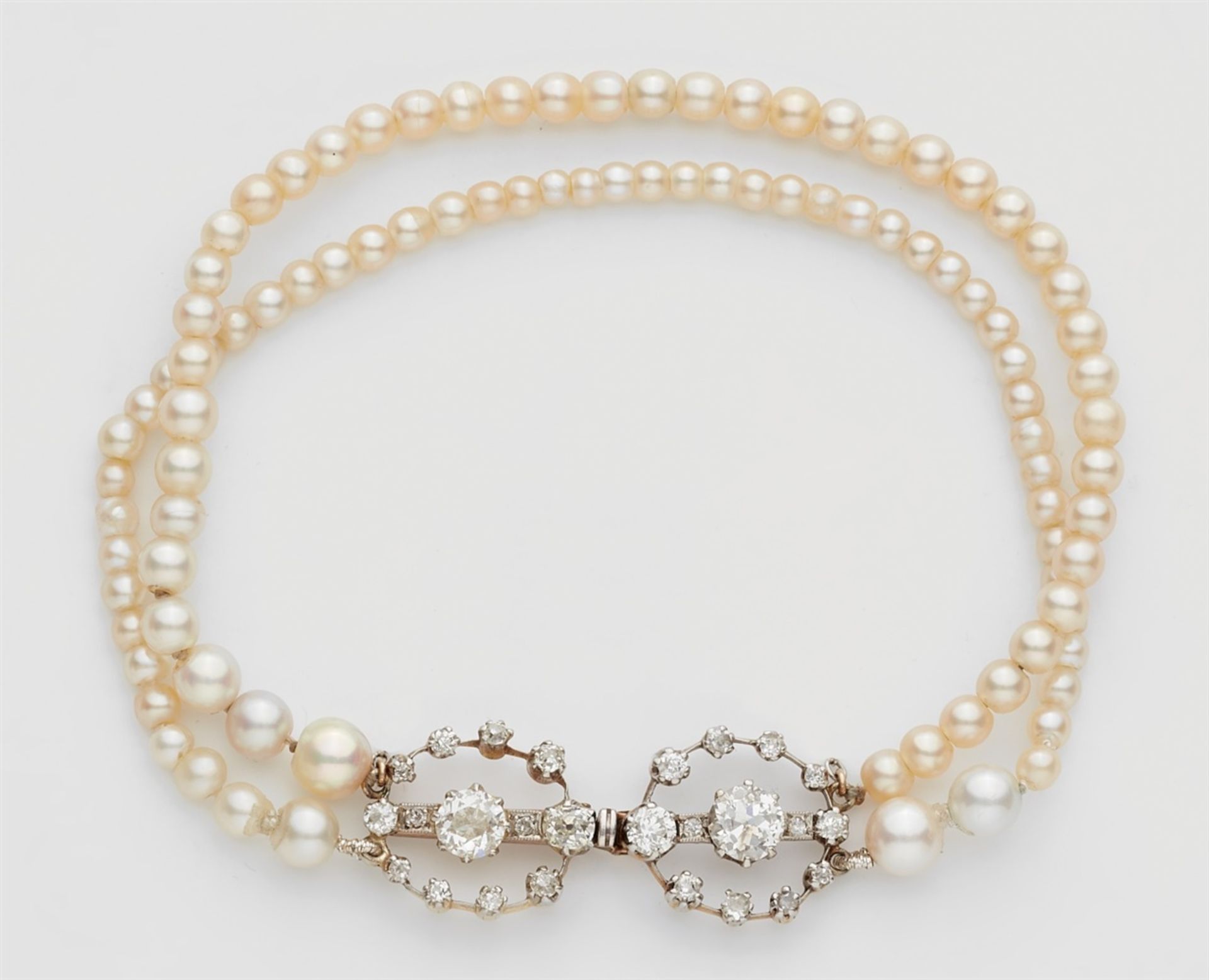 An Oriental pearl bracelet with a diamond claspA two-stranded bracelet made from 44/52 small