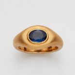 An 18k gold and sapphire ringThe solid forged matte gold band set with an oval sapphire (c. 1.28 ct,