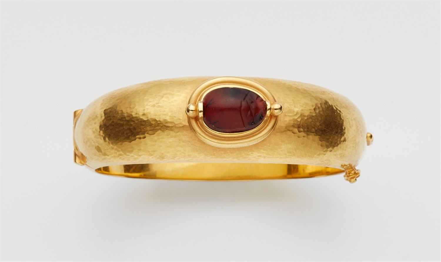 An 18k gold carnelian scarab bangleForged bangle with martelé decor with an ancient Egyptian