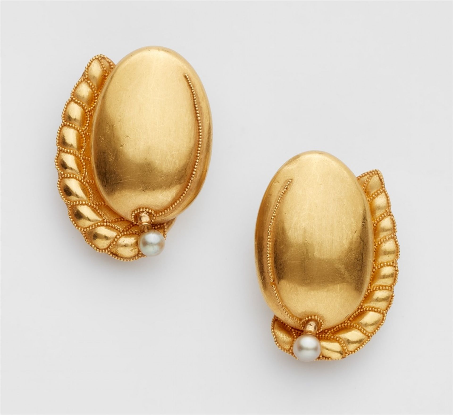 A pair of 18k gold clip earrings with granulationHollow gold earrings shaped like plums with