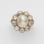 A Belle Epoque diamond and pearl ringA platinum ring with diamond set shoulders and a flower-