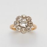 An 18k gold and diamond cluster ringThe bezel cluster set with nine cushion shaped old-cut