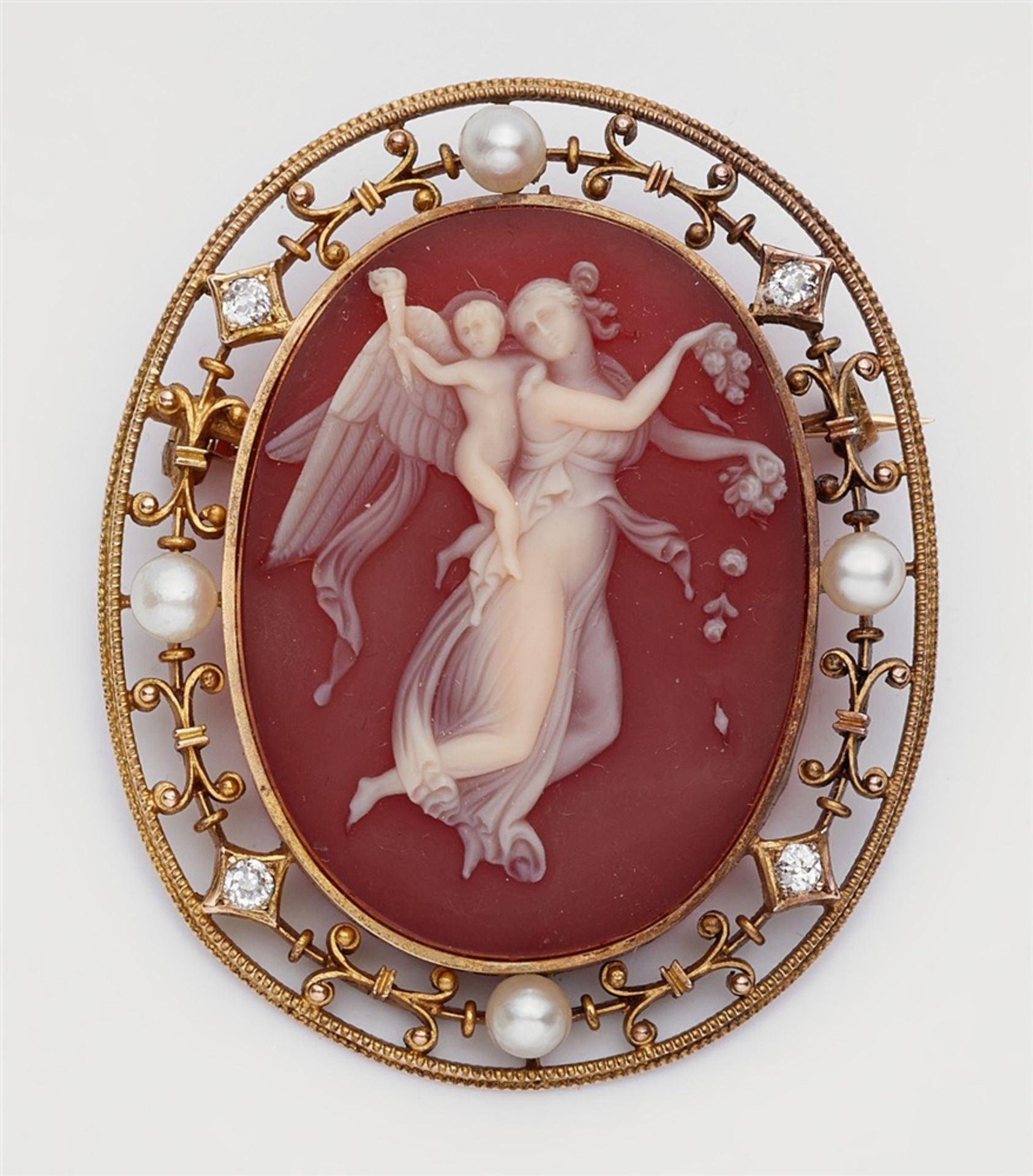A 14k gold and agate cameo broochSet with an oval layered carnelian plaque finely carved with a
