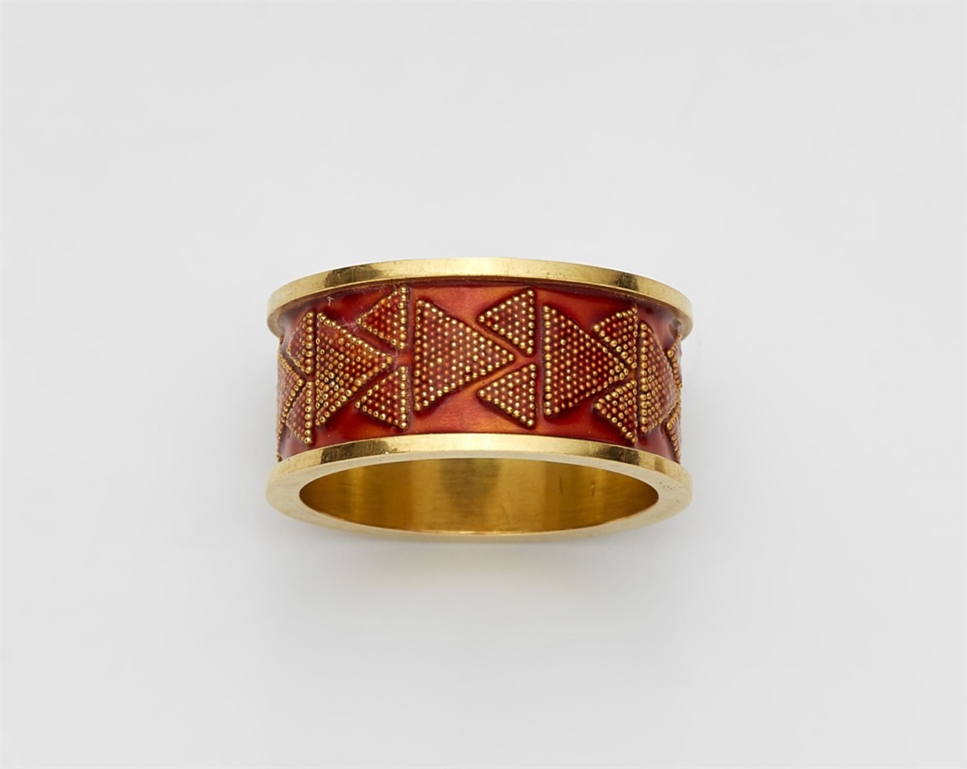 An 18k gold and enamel ring with granulationForged band hoop with profiled edges. Decorated with