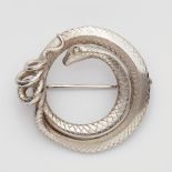 An 18k white gold snake broochRing shaped brooch with stylised snakeskin engraving, the eye set with