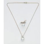 A pearl and diamond demi-parureComprising a pedant necklace and a ring. Custom-made design using