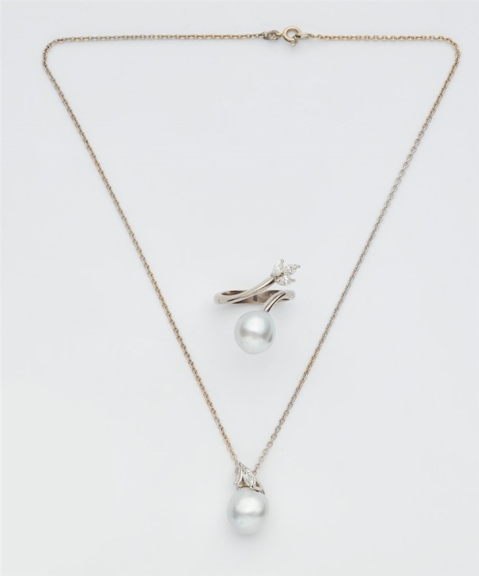 A pearl and diamond demi-parureComprising a pedant necklace and a ring. Custom-made design using