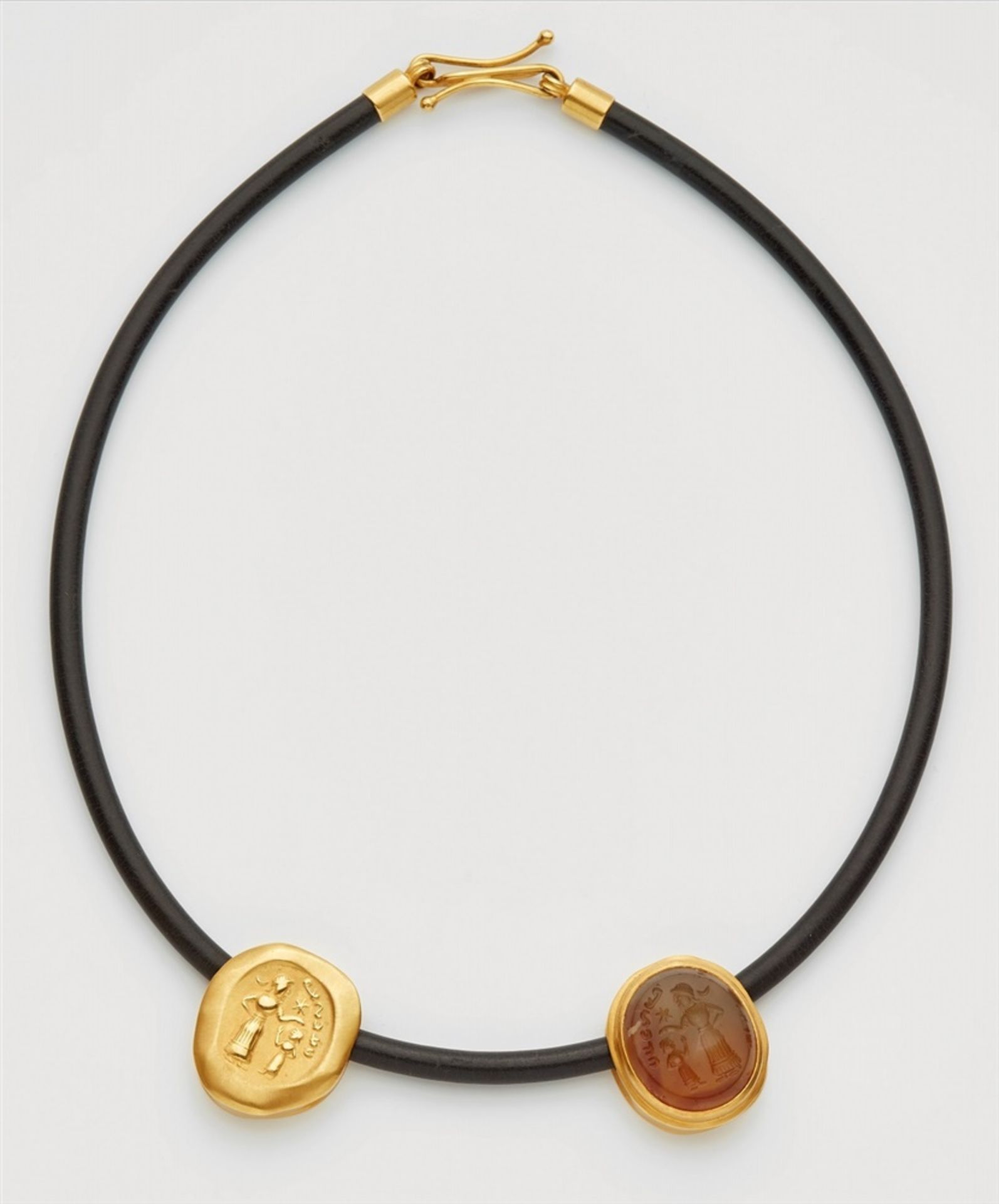 A necklace with a Bactrian carnelian intaglio and its 18k gold impressionTwo pendants set with a