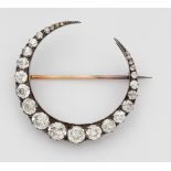 A diamond half moon broochA 14k gold and silver brooch set with six tiny rose-cut diamonds and 19