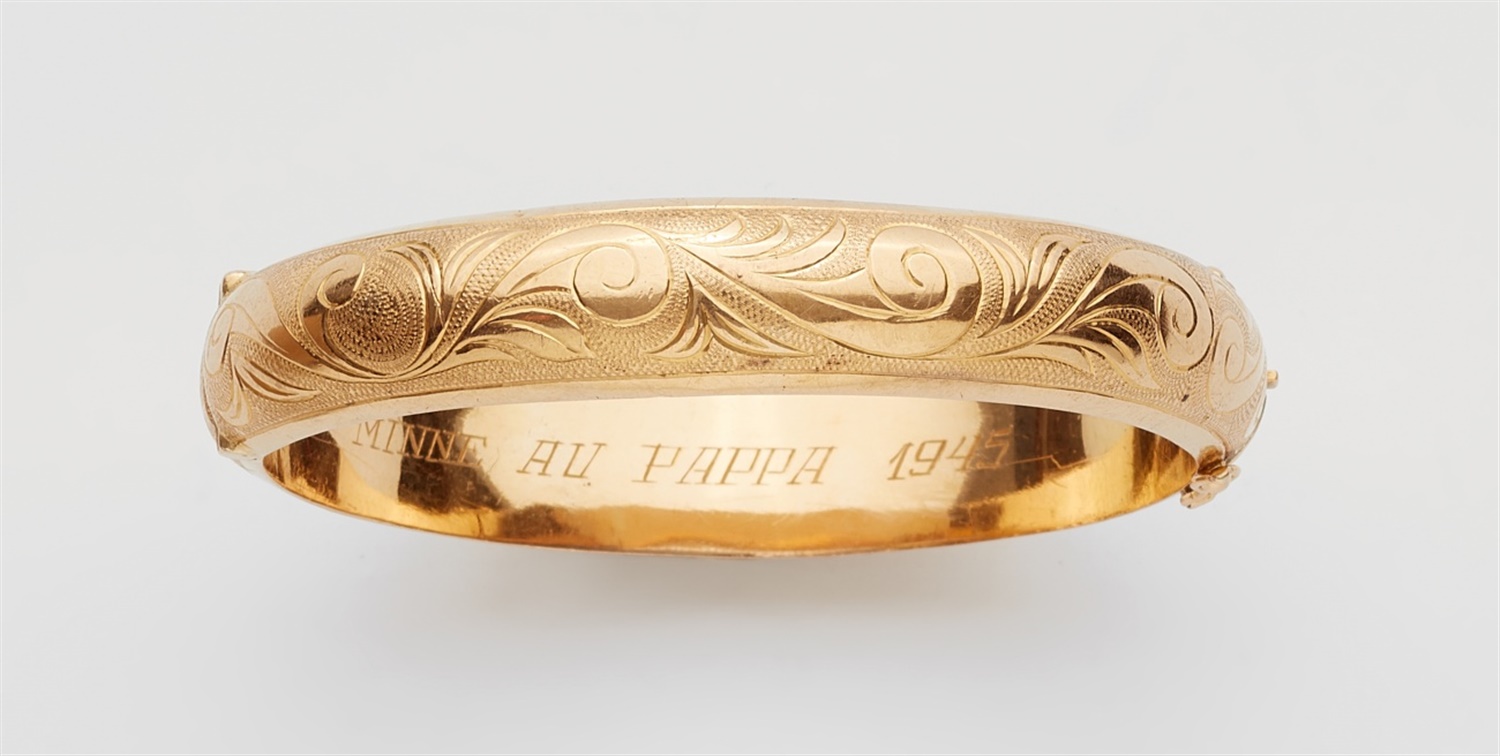 An 18k gold Swedish braceletDomed bangle with a hinge to one side. Engraved Historicist tendril